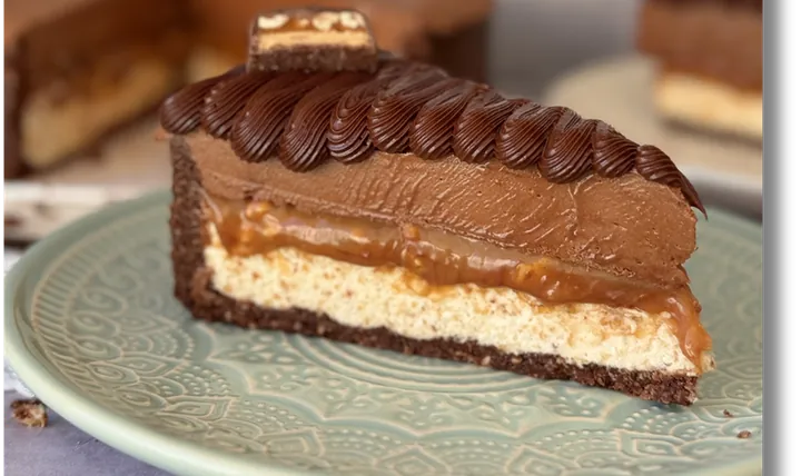 Fatia da torta tipo Snickers com caramelo salgado de amendoim e brigadeiros